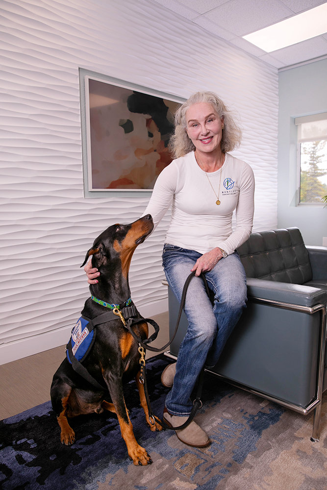 Clementine Bentley, who is autistic, is owner of Bentley Skincare & Wellness, which employs three. With her is service dog, Abel.